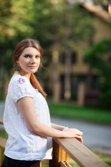 Young woman on small wooden bridge