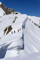 Fototapeta na wymiar Snowboarders walking uphill for freeride