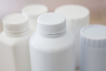 many medicine bottle with blur shelves of drug in the pharmacy d