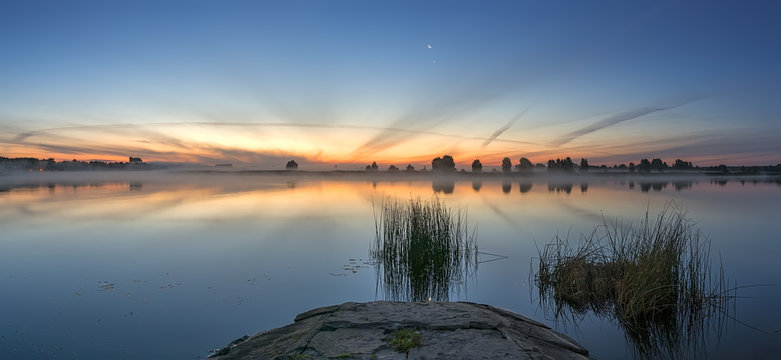 Panoramic view on sunrise with crescent moon. Photo was taken stone pier in Jurmala resort, Latvia