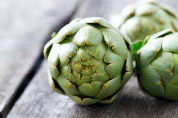 Fototapeta premium artichokes on wooden surface