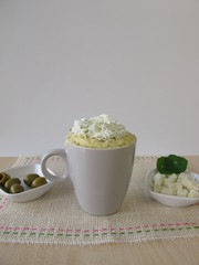 Mug cake with olives, feta cheese and herb cheese topping