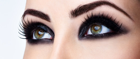 Closeup shot of woman eye with evening makeup. Long eyelashes. S