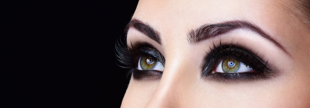 Closeup shot of woman eye with evening makeup. Long eyelashes. S