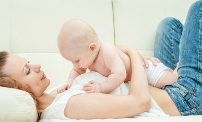 Mother and baby playing and smiling. Happy family.Home interior.