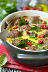Meatballs baked in omelet.