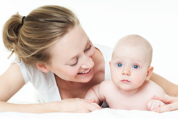 Mother and baby playing and smiling. Happy family.