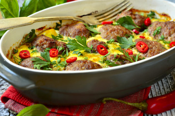 Meatballs baked in omelet.