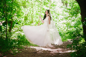Beautiful happy young brunette bride outdoors in wedding dress,hairstyle, make-up, wedding,...