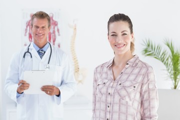 Doctor and patient smiling at camera