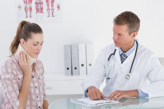 Doctor talking to patient wearing neck brace