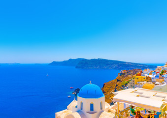 The blue colored dome of an old  traditional church in Oia the most beautiful village of Santorini island in Greece
