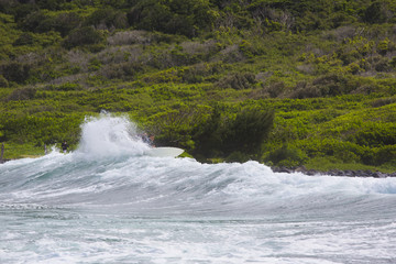 Surfer slashes a wave