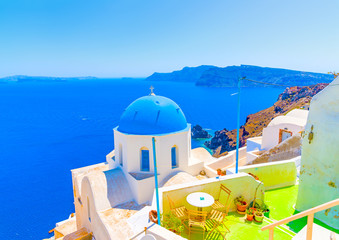 Traditional old church with blue colored dome in Oia the most beautiful village of Santorini island in Greece