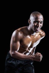 Fototapeta na wymiar Muscular man smiling while running