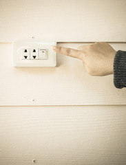 female finger switching light on or off.Electrical element to turn light and electricity on and off