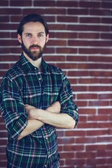 Portrait of confident hipster with arms crossed 