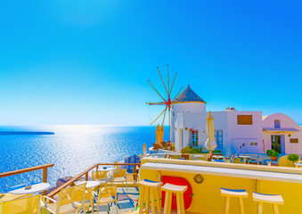 Amazing view to the sea including a pictorial old traditional windmill in Oia the most beautiful village of Santorini island in Greece - 91051022