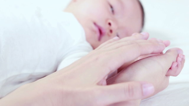The sleeping baby in the hand of mother close-up
