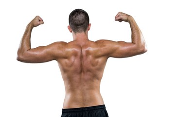 Rear view of shirtless athlete flexing muscles