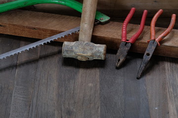 Old carpenter tools on wooden background