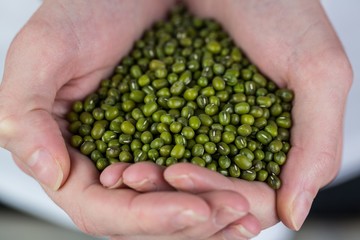 Woman showing handful of lentils