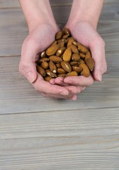 Woman showing handful of almonds