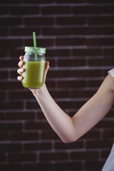 Pretty woman sipping on green juice