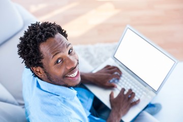 High angle portrait of man working on laptop 
