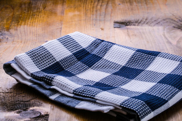 Canvas checkered cloth loosely laid on a wooden table 