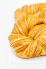 Closeup fresh and tasty croissant on white background