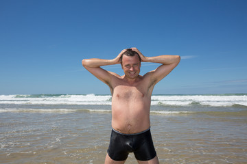 Fototapeta na wymiar Man having fun at the beach during summertime