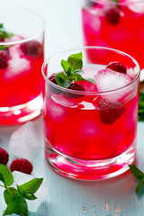 Fototapeta na wymiar cold drink with raspberry, mint and ice