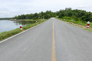 Fototapeta premium road beside the pond in the park