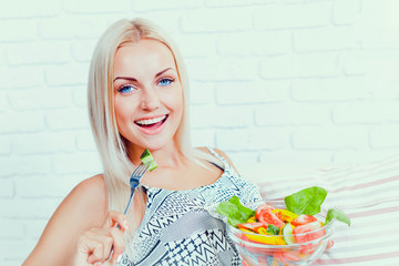 Beautiful girl eating fresh vegetable salad