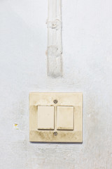Old electric switch and electric cable at wall