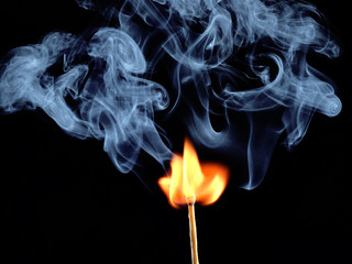 Ignition of match with smoke, isolated on black background