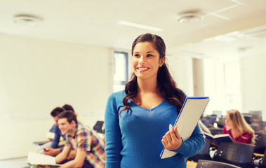 group of smiling students in lecture hall