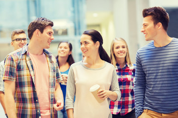 group of smiling students with paper coffee cups