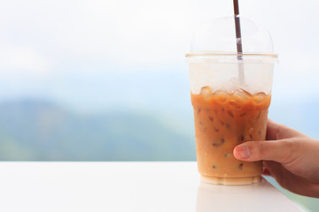 woman's hand hold ice coffee cup