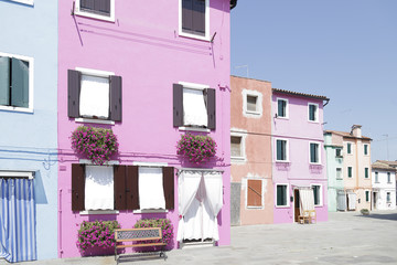 Naklejka premium One street of the island of Burano (Venice, Italy) with its houses of different colors