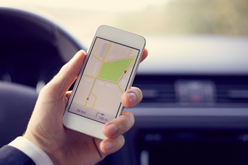 Man holding mobile with map gps navigation, toned