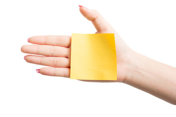 Woman hand holding blank yellow notepaper