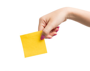 Woman hand holding blank yellow notepaper