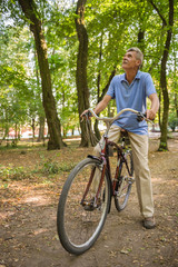 Naklejka premium Senior man with bicycle