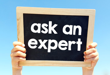 Hands holding blackboard with handwritten ask an expert