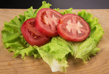 the sliced tomatoes on a chopping Board
