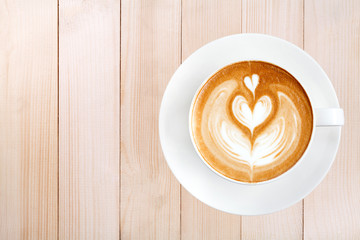 Top view latte art coffee on wood background