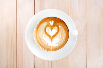 Top view latte art coffee on wood background