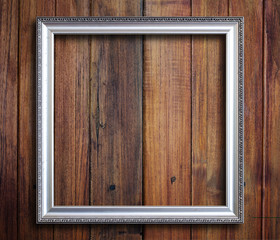 Old picture frame on vintage wood wall.